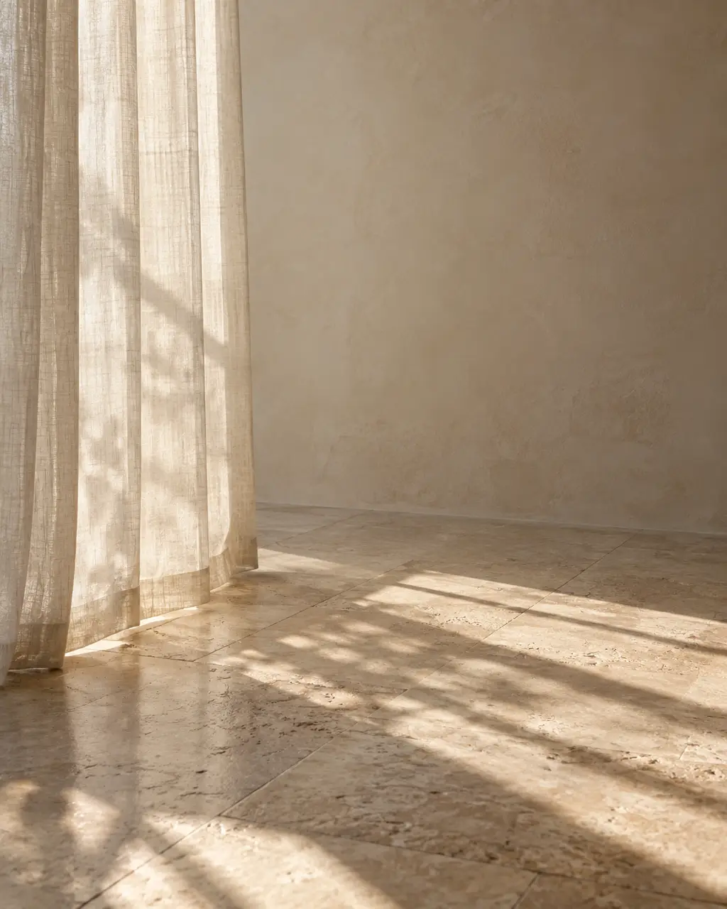 Sheer curtain light on a plaster wall