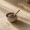 Chia seeds, photographed on stone.