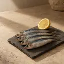 Sardines, photographed on stone.