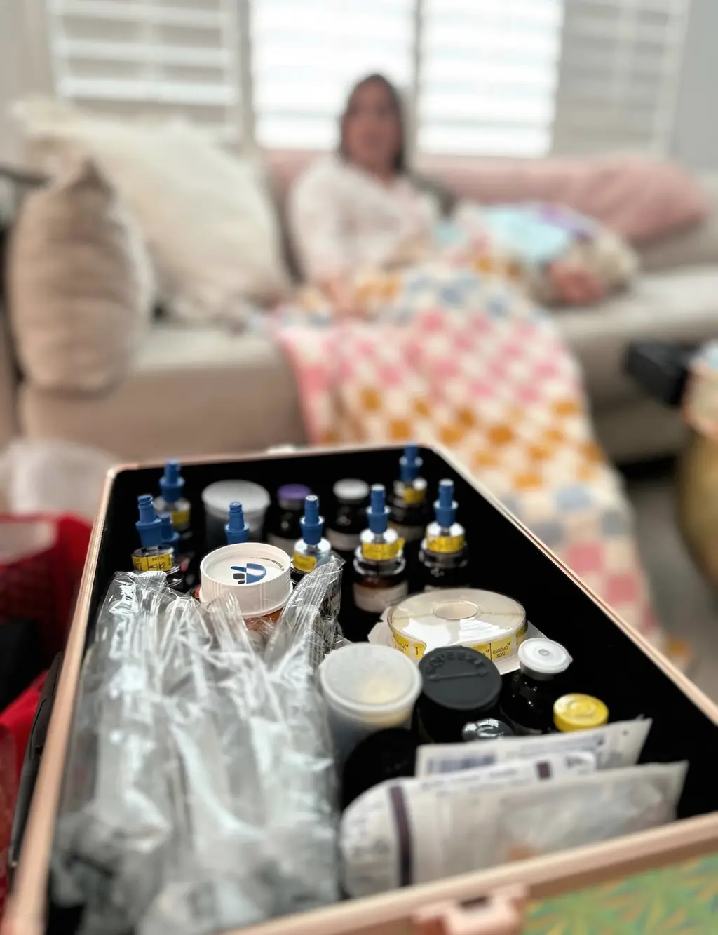 A nurse's supply case open in a living room during a visit