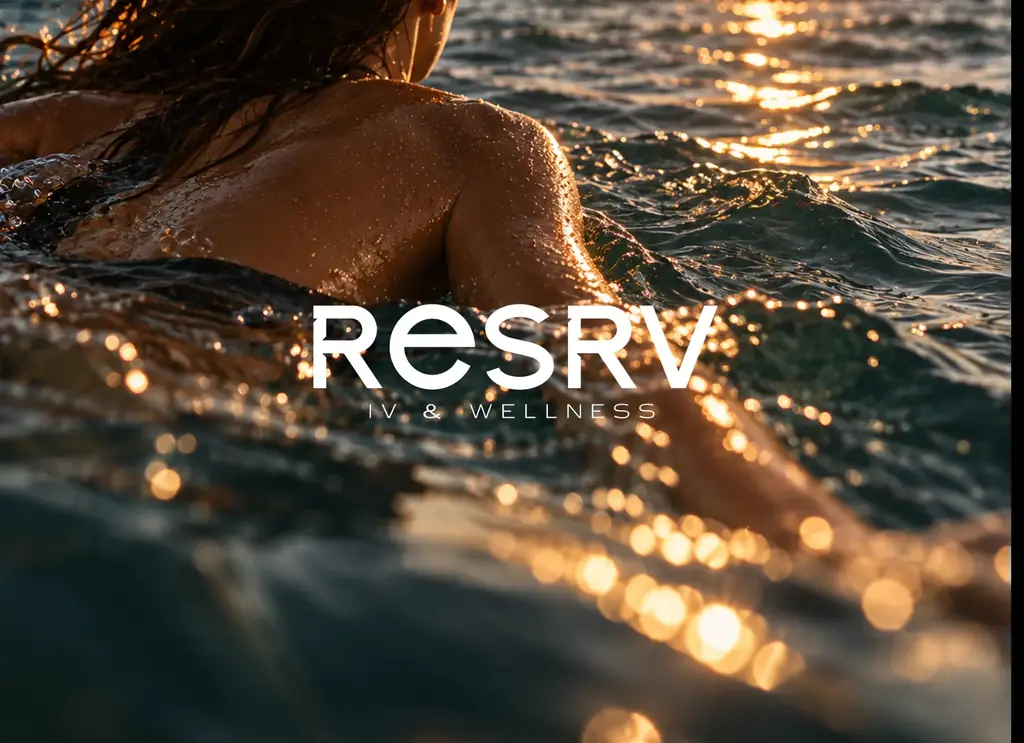 A swimmer in the ocean at golden hour, sunlight on the water